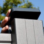 modern black aluminum fence panels installed on property backyard