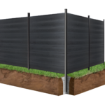 Black composite fence panels with co-extrusion forming a corner fence on grassy soil.