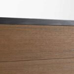 Brown composite fence with walnut finish, durable co-extrusion design, ideal for NJ decks with black metal railings.